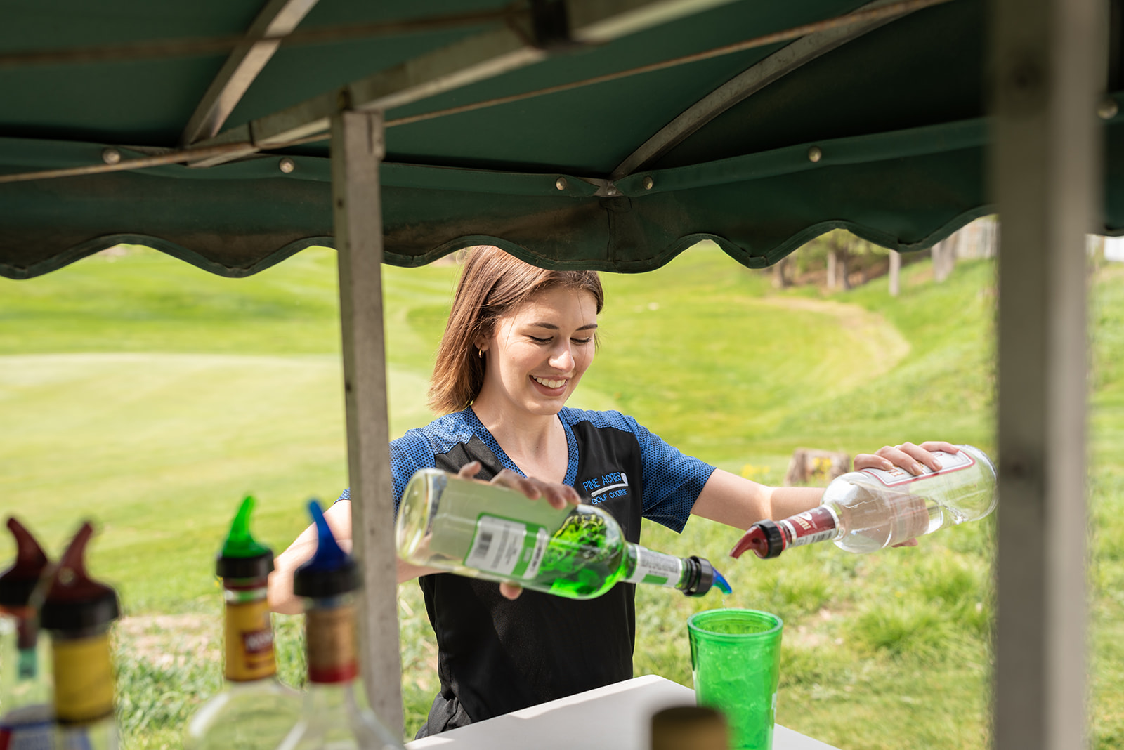 bartender serving drinks from the drink cart at Pine Acres